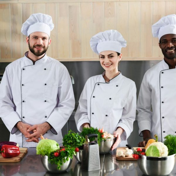 multiracial-chefs-team-smiling-by-modern-kitchen-counter.jpg